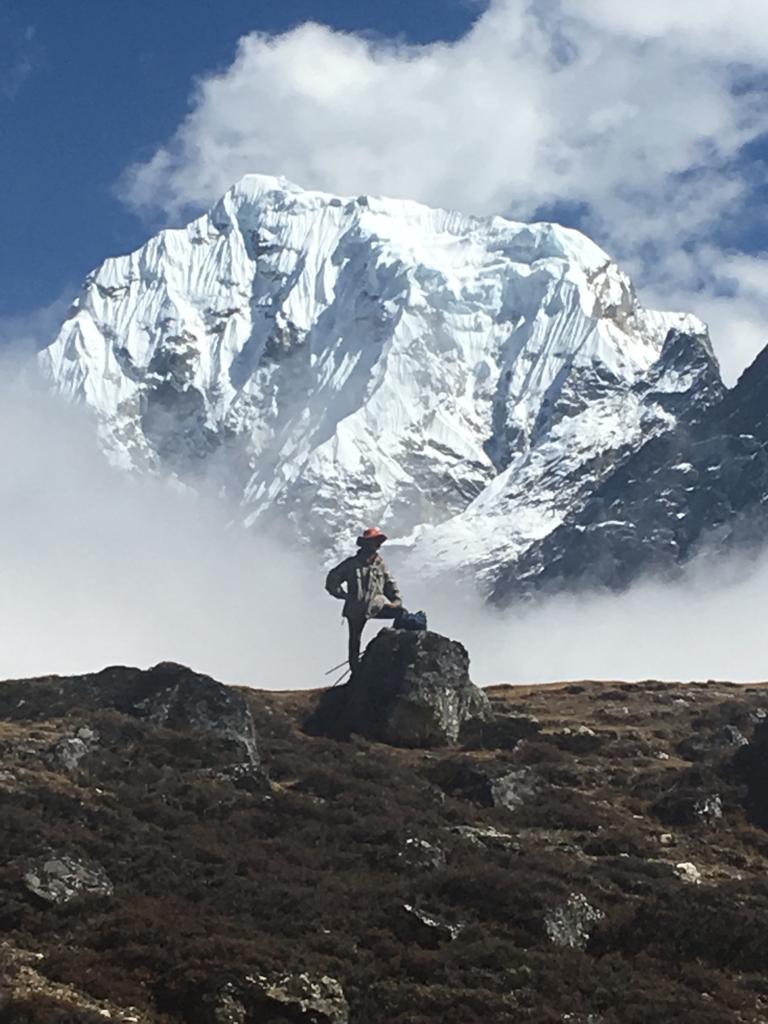 a person standing on top of a snow covered mountain