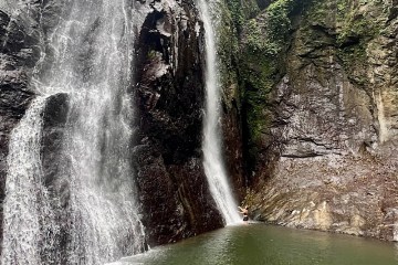 a large waterfall over a body of water